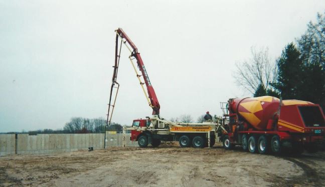 Red-D-Mix concrete pump truck and mixer on the job